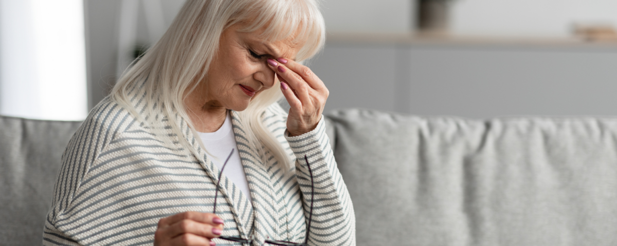 Woman holding area between eyes in fatigue